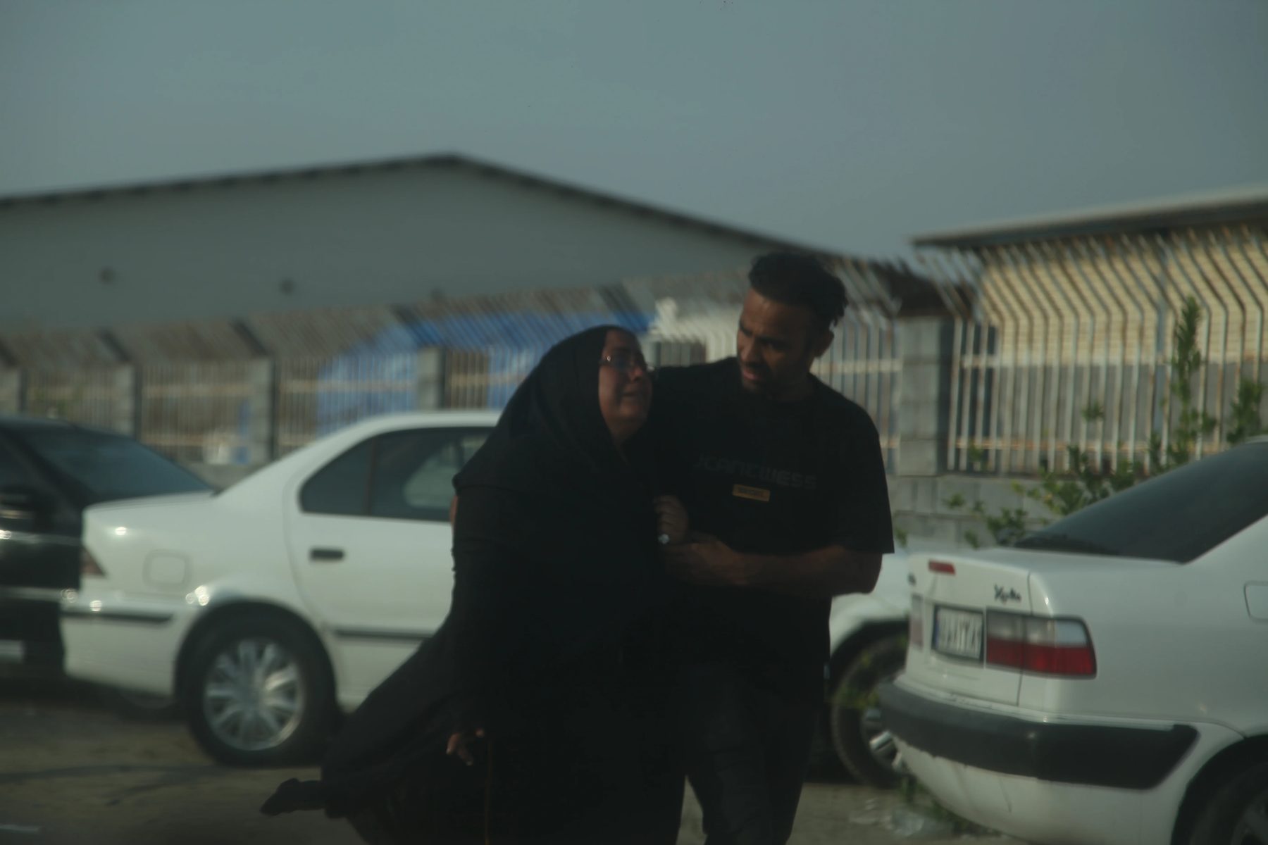 A grieving woman supported by a relative