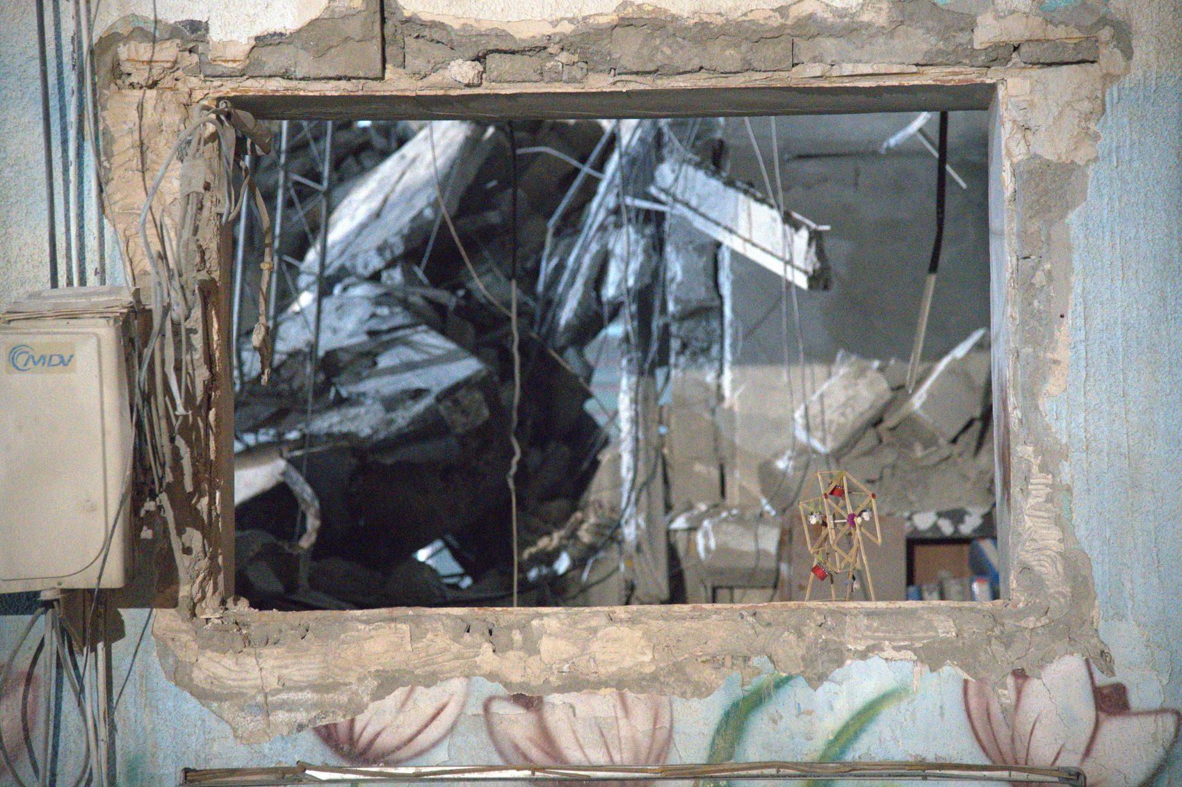 A classroom window above a painted lotus mural