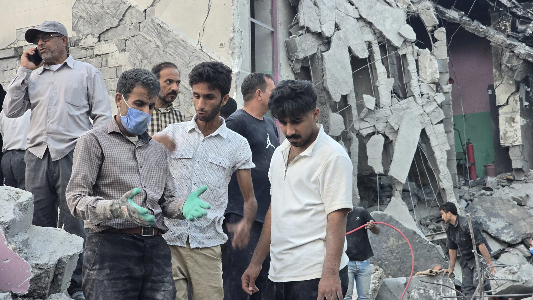 People gathered at the collapsed building